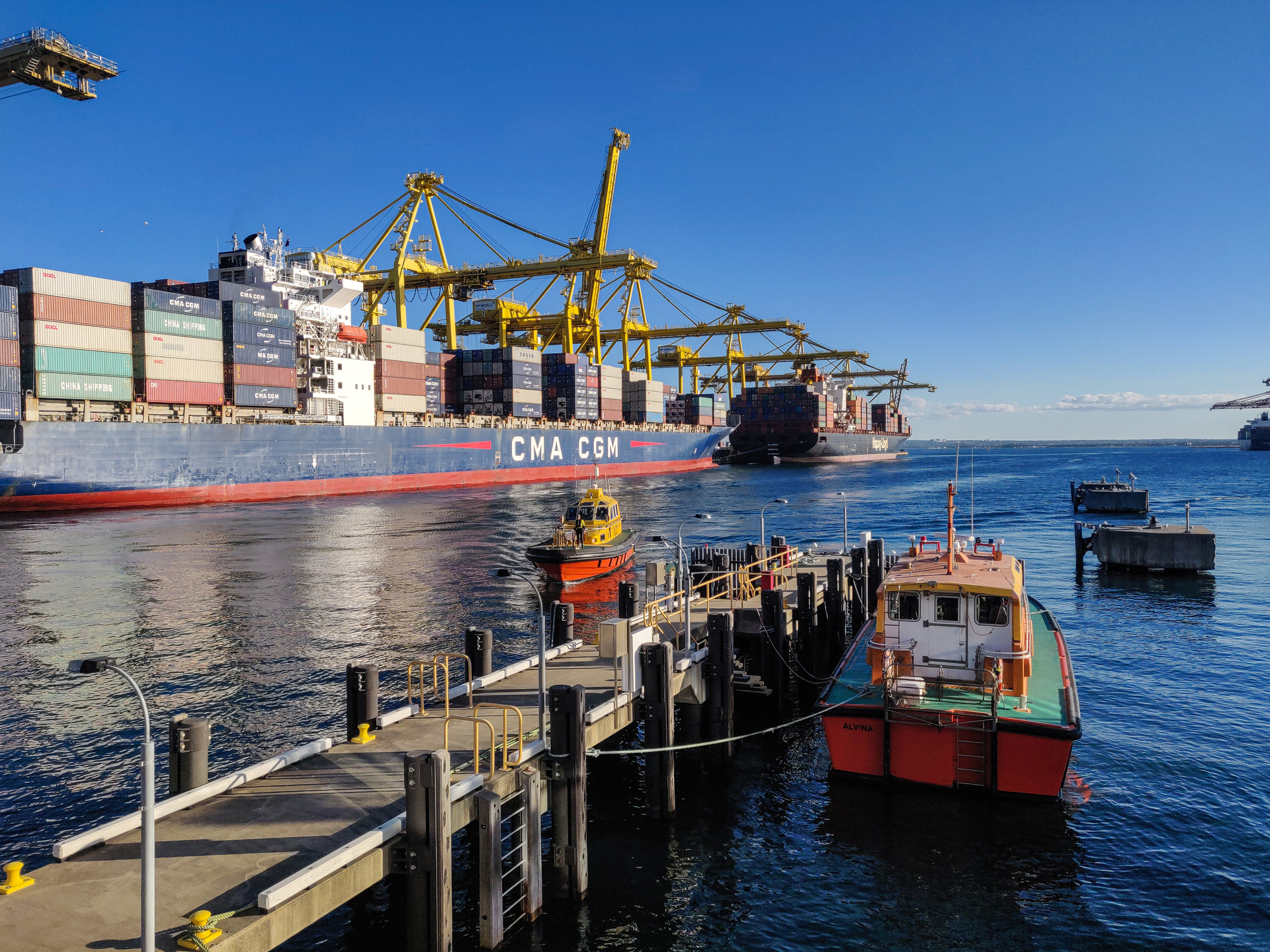 A Port Authority vessel is moored at Port Botany and another coming in with two bulk carriers in the background
