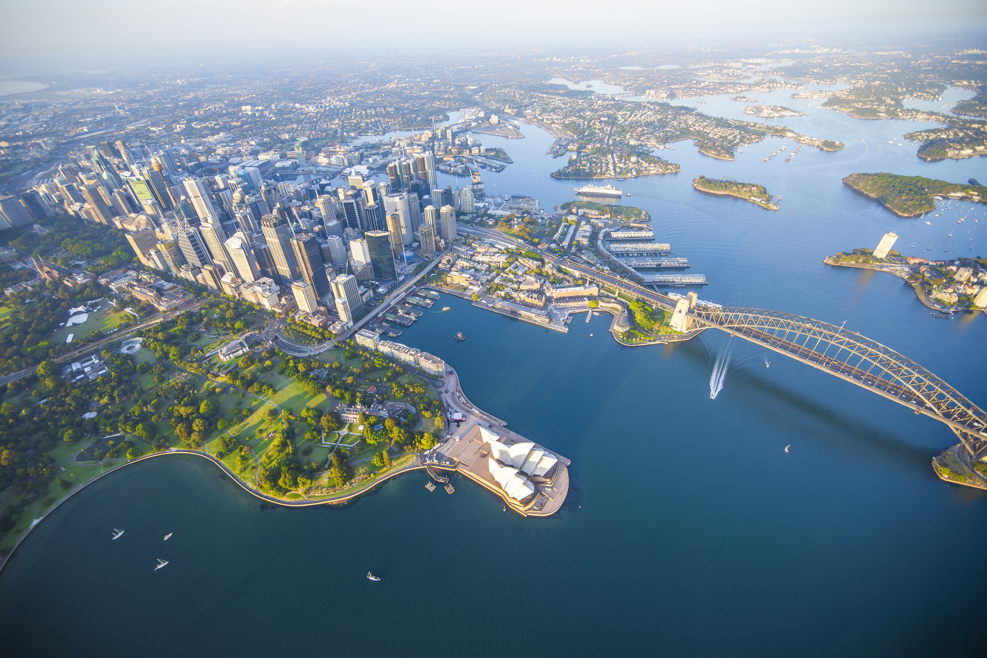 Aerial view of Sydney Harbour and CBD with Harbour Bridge and Opera House in foreground