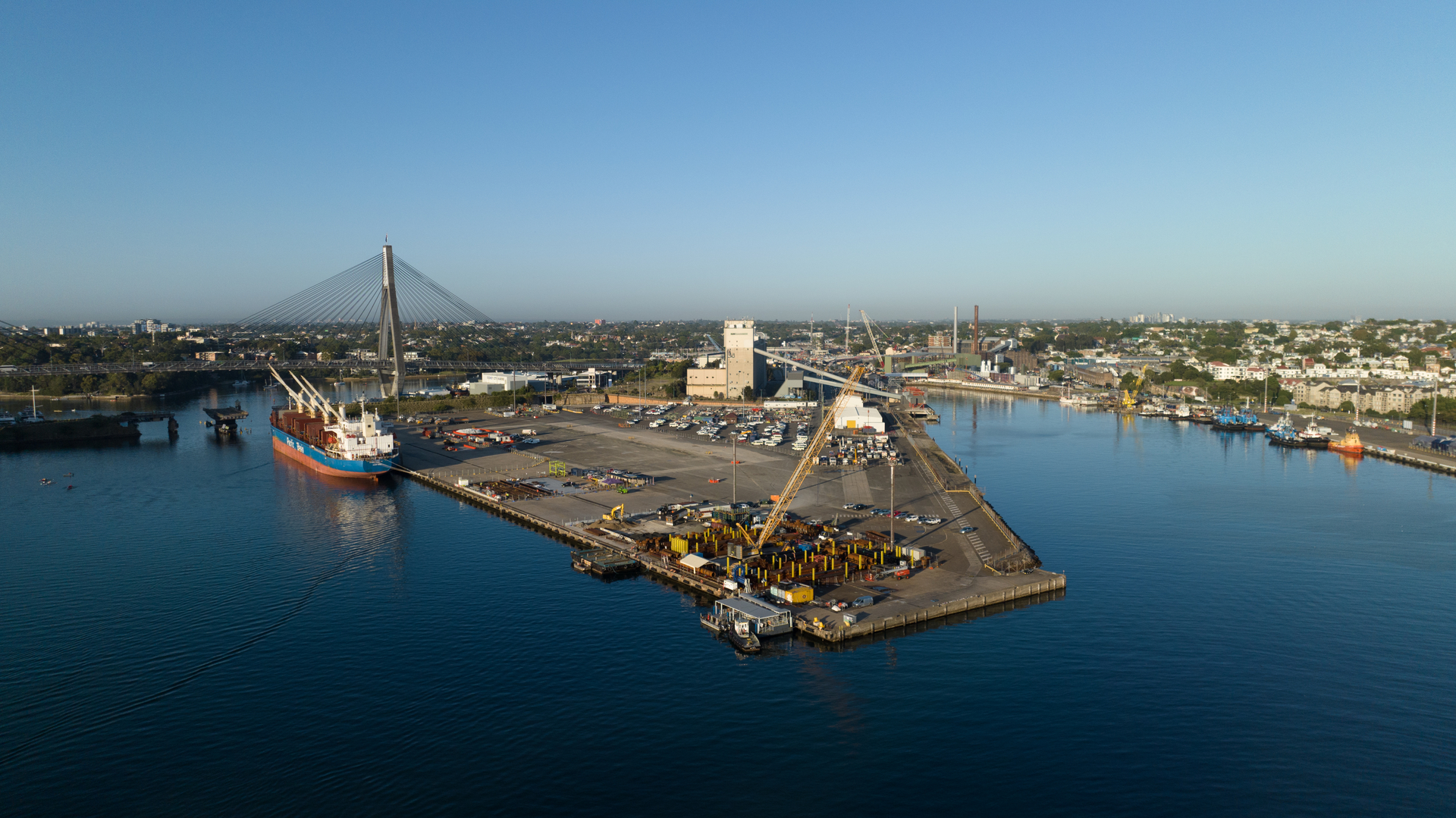 Aerial view of a bulk carrier alongside Glebe Island with the Anzac Bridge in the distance