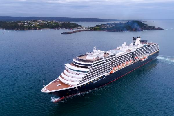Aerial of a cruise ship off Port of Eden with Eden town in the distant background