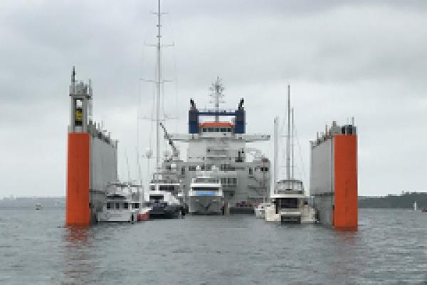 Semi-submersible ship loads yachts bound for NY