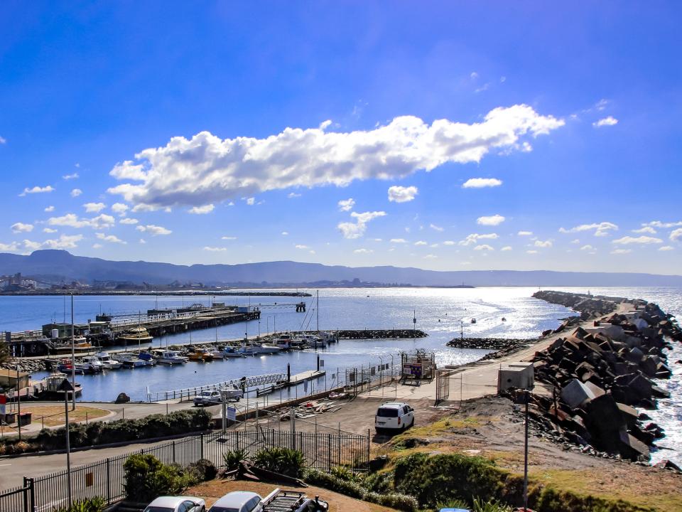 The bays in Port Kembla with vessels on the water and vehicles ashore