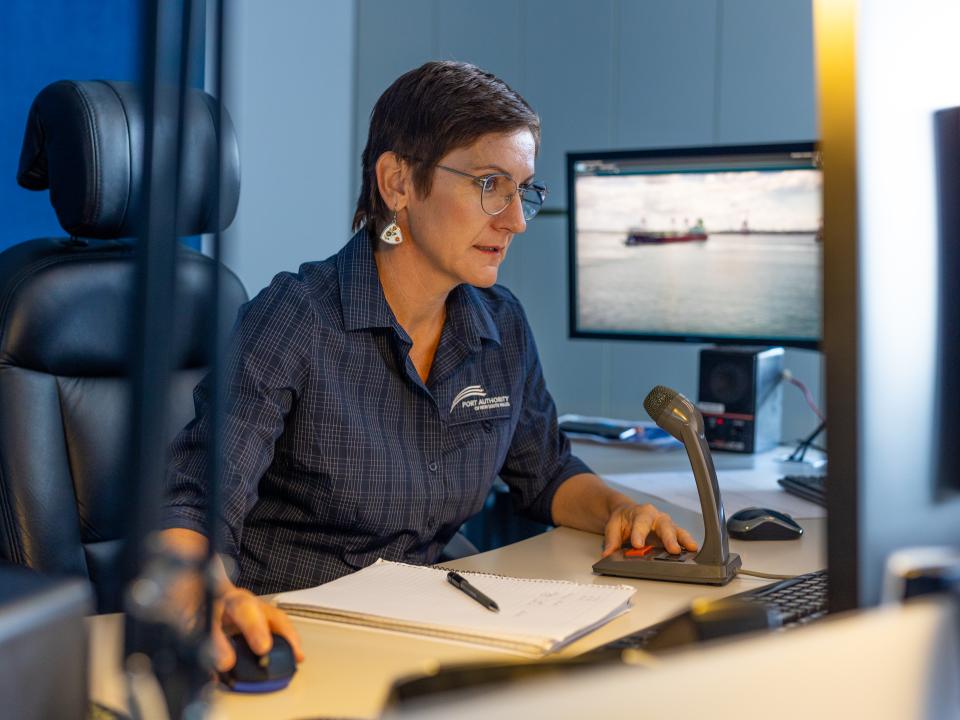 A VTS employee at her desk looking at a computer monitor