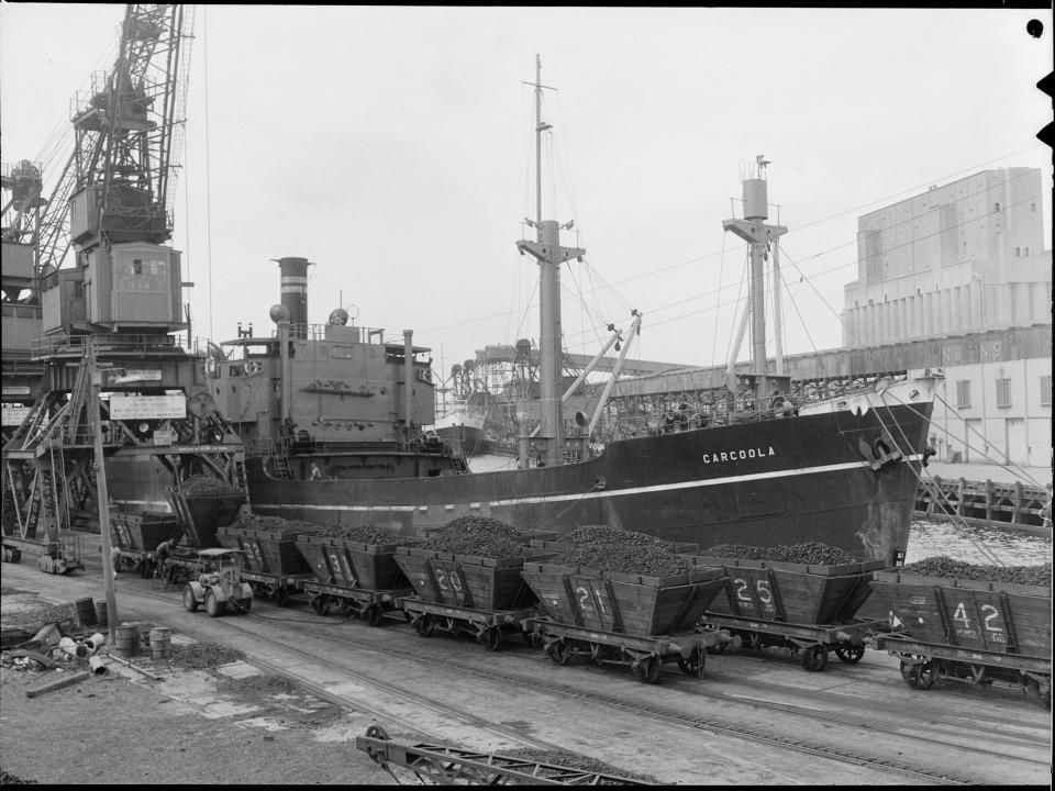 loading coal from rail trucks to ship and white bay historical image