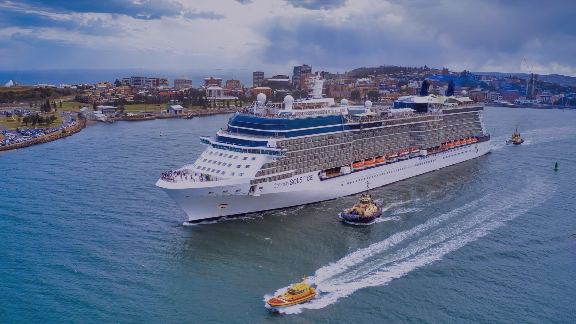 Cruise ship departs Newcastle with residential areas in distance