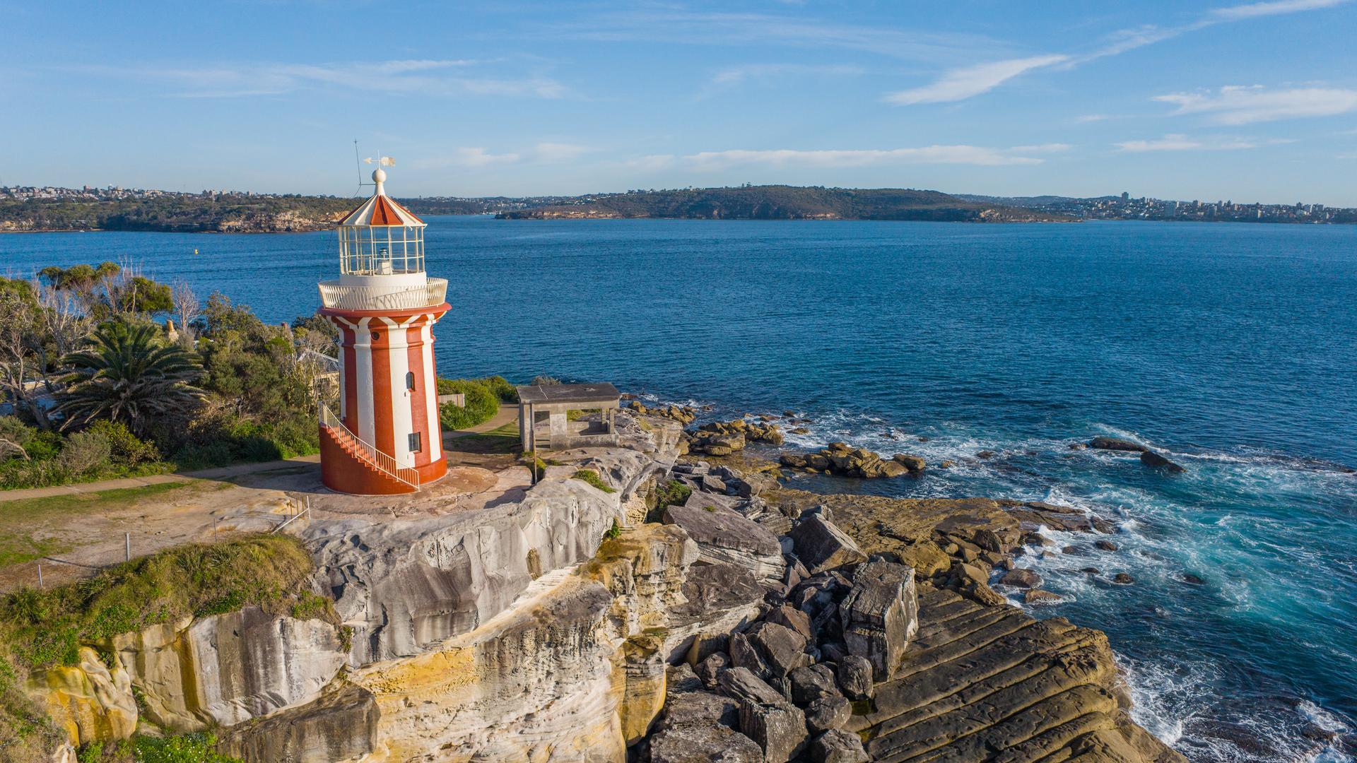 Hornby Lighthouse on top of a hill and open waters at the mouth of Sydney Harbour