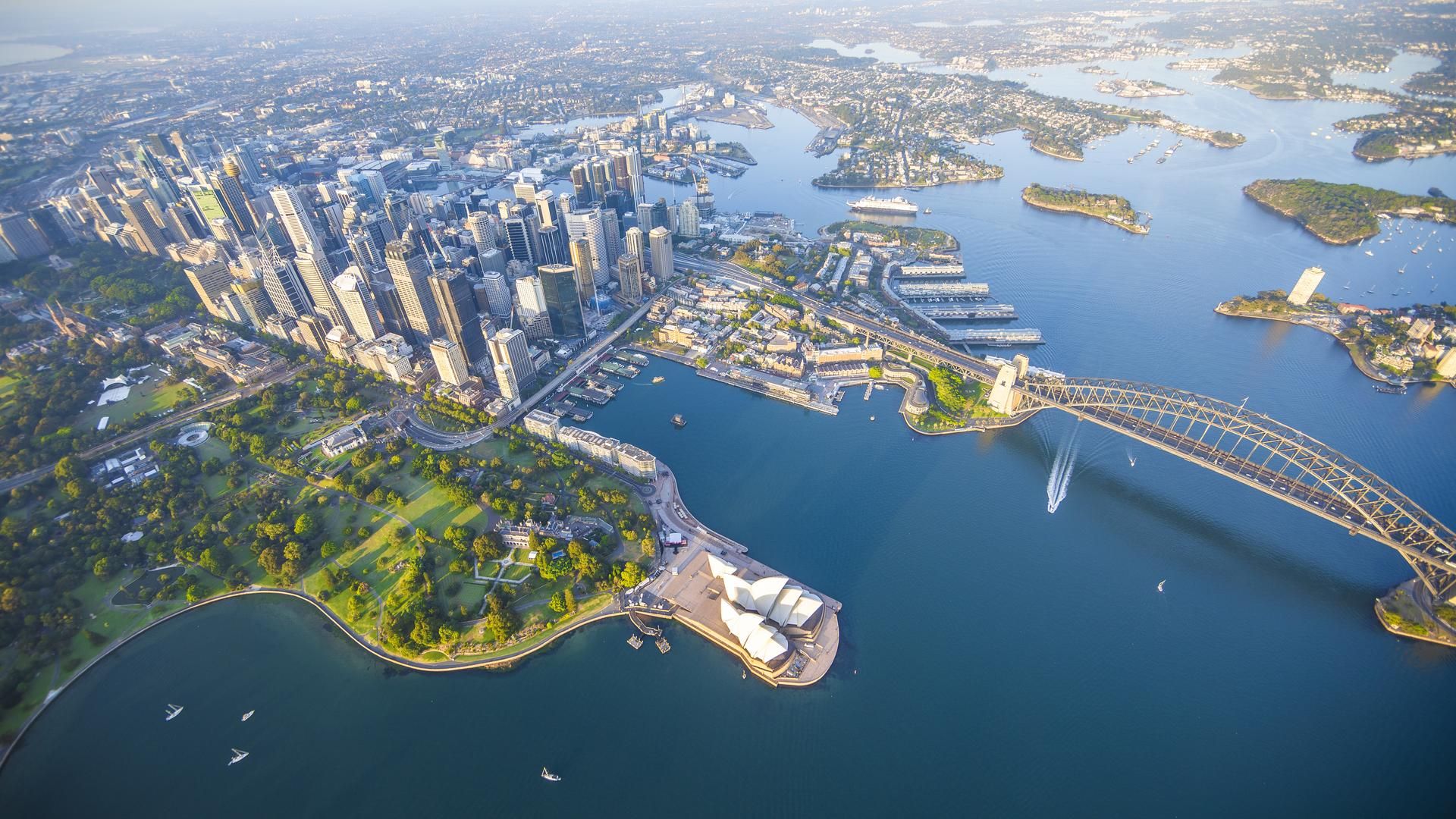 Aerial view of Sydney Harbour and CBD with Harbour Bridge and Opera House in foreground