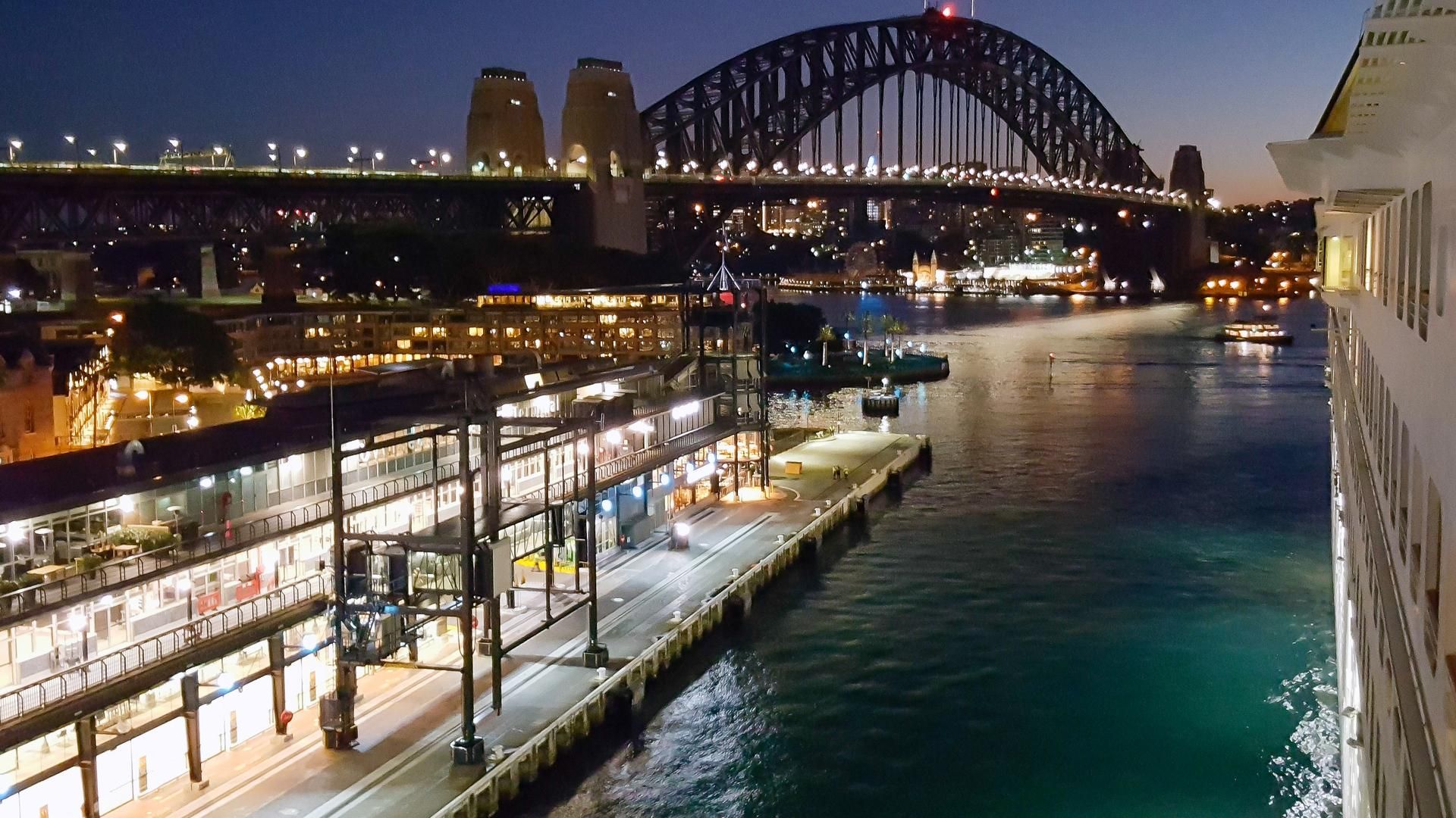 A cruise ship comes in to berth at the Overseas Passenger Terminal with the Harbour Bridge in the background