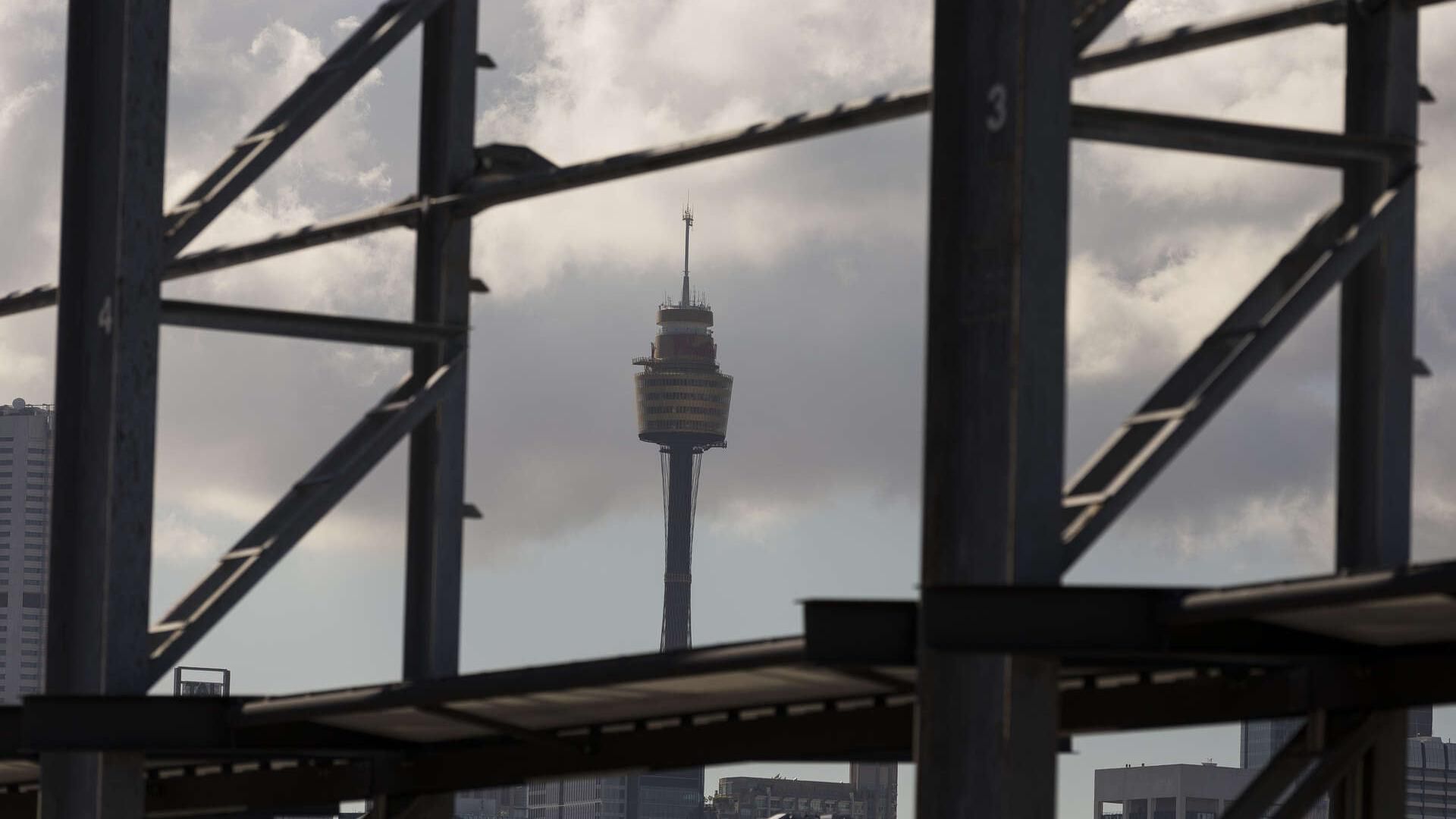 Looking through car park open scaffolding sides to the Sydney Tower in focus