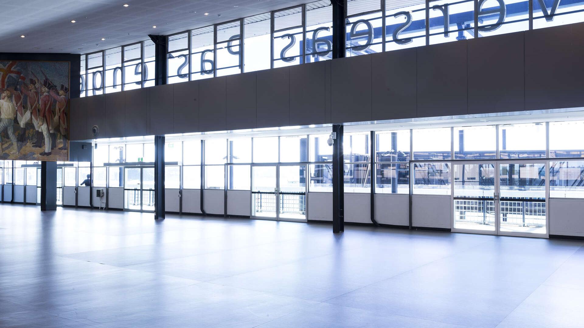 Inside the empty Customs Hall with a bright outside