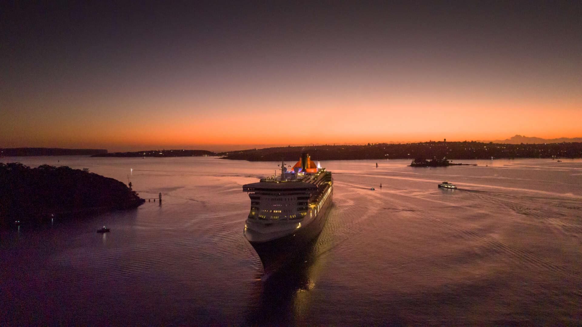 Queen Mary 2 entering Sydney Harbour during a pink sunrise