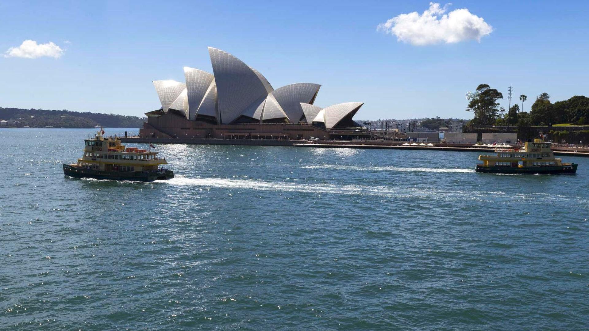 Ferry and boat on Sydney Harbour in front of Sydney Opera House
