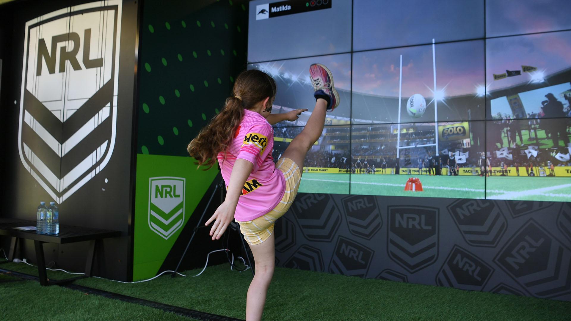 Girl kicking football. Action from NRL Fan Fest 2024 at Overseas Passenger Terminal
