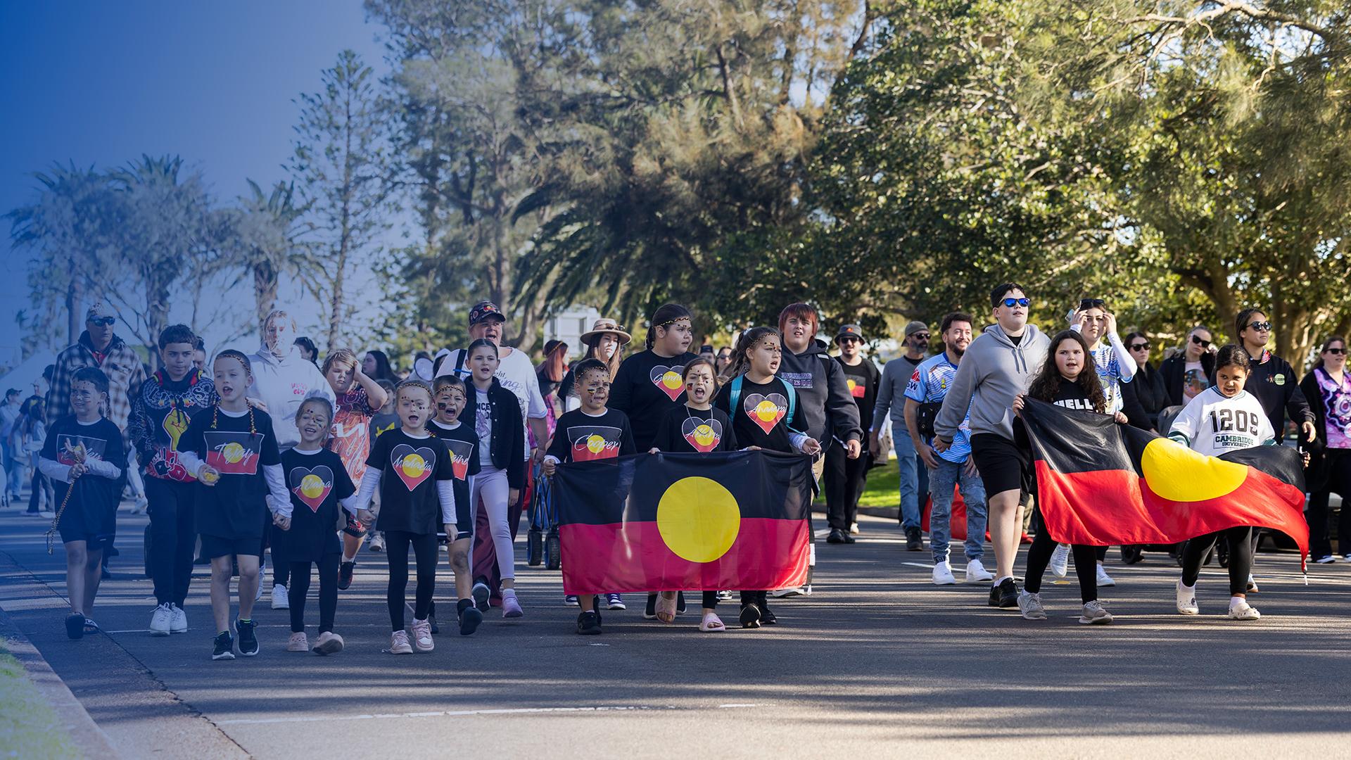 NAIDOC Week Newcastle march with flags